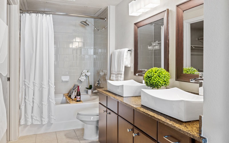 Large well lit bathrooms with modernly designed sinks 